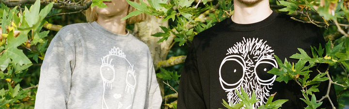 Woman and man with Quipster sweatshirts in nature